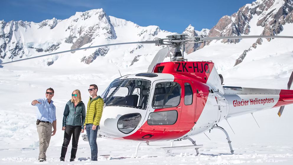 glacier helicopters carousel helicopter pilot pointing out glacier features on a snow landing